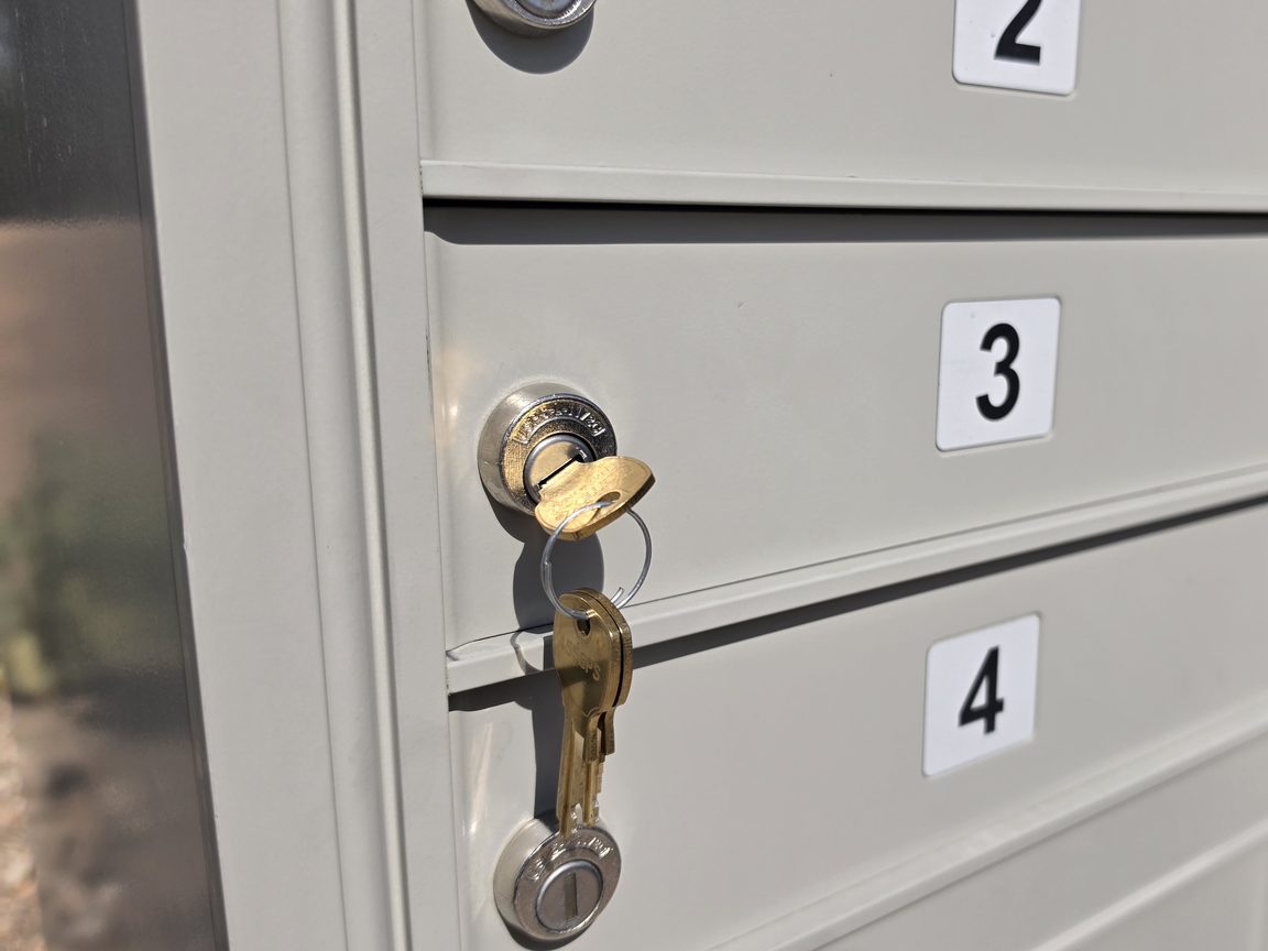 New USPS-approved lock with keys installed on a cluster mailbox door in Tucson